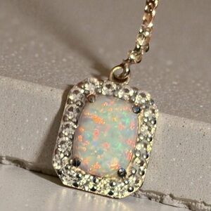 Beautiful Sterling silver Opal and white topaz earrings and pendant set.